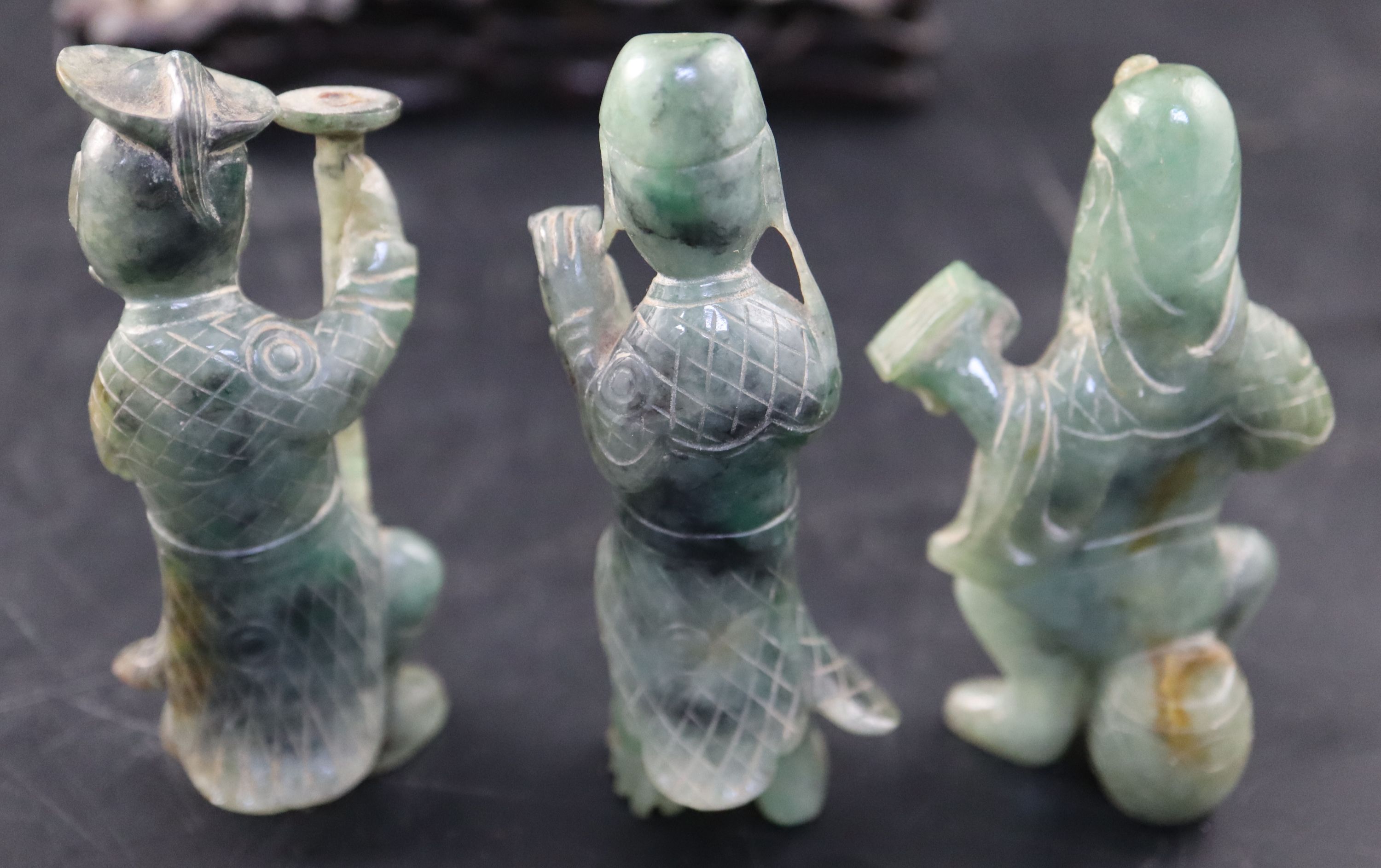 A set of three Chinese carved hardstone figures of immortals, stand; shi shi, malachite fragments etc.